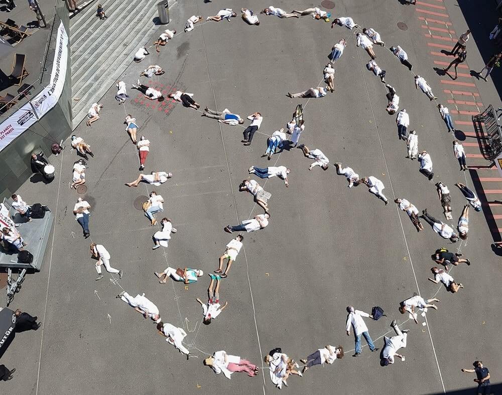 Rebels lying "dead" in the shape of the XR logo