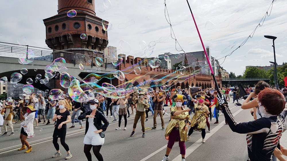 Rebels dancing on a bridge amongst bubbles