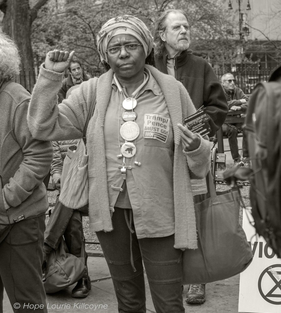 Woman in a headscarf holding her hand up in a fist